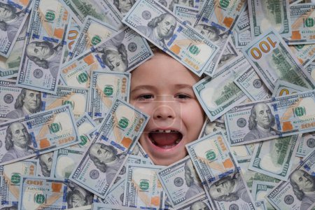 Téléchargez les photos : Funny child with fun face with money. Kid peeking out of dollar bills with astonished shocked eyes. Money background. Money banknotes, cash dollars bills - en image libre de droit