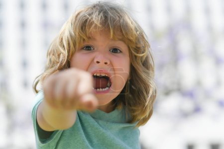 Photo for Boy fight with fist gesture punch. Kid boy with angry expression. Angry hateful little crazy boy, child furious. Angry rage kids face. Aggressive and mad kid angry behavior - Royalty Free Image