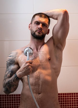 Foto de Shower. Guy taking shower in bathroom. Relaxing time. Fresh shower. Good looking man is under water drops - Imagen libre de derechos