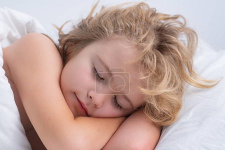 Téléchargez les photos : Good morning sleep. Child boy take nap. Kid sleeping in bed. Comfortable mattress on bedroom. Soft pillow, comfy, cozy comfortable bed concept. Healthy kids sleeping - en image libre de droit