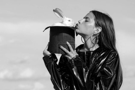Photo for Easter kiss woman. Magician Funny rabbit, stylish clothing. Alice in Wonderland. Plush bunny. Fashion concept - Royalty Free Image
