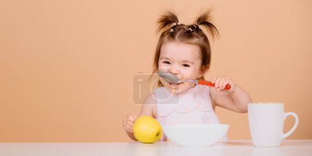 Photo for Baby food, babies eating. Little baby eating fruit puree - Royalty Free Image