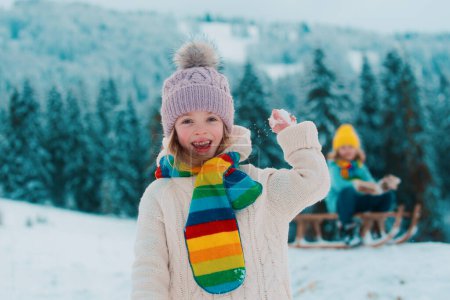 Photo for Little girl and boy enjoying a day out playing in the winter forest. Children siblings having fun in beautiful winter park - Royalty Free Image