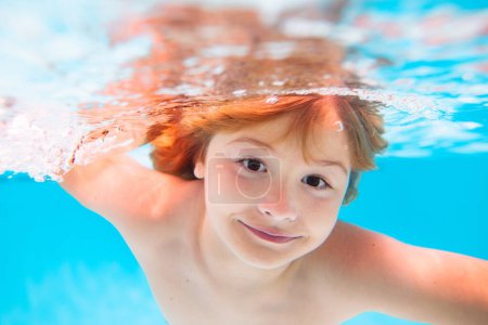 Photo for Child swim and dive underwater in the swimming pool. Kids swim on summer vacation - Royalty Free Image
