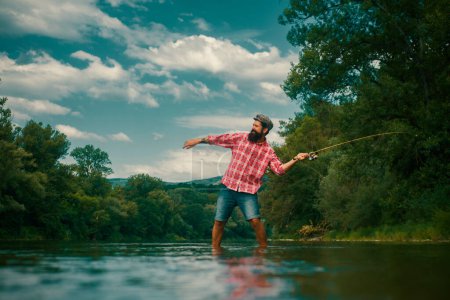 Photo for Big game fishing. Hobby of businessman. Fly fish hobby of man in checkered shirt. Young man fishing. It is so big. Bearded man fishing. Strategy. Trout bait - Royalty Free Image
