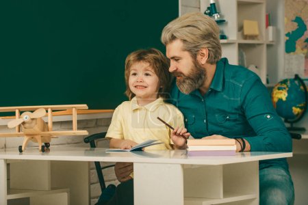 Photo for School community partnership models. Elementary school classroom. Pupils Education. Educational process. Cute pupil and his father schooling work - Royalty Free Image