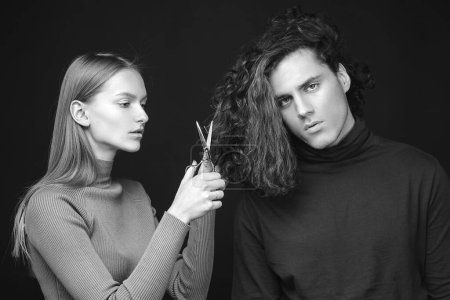Photo for Hair salon concept. Hairdresser girl going to cut off long wavy bleached dry hair of customer man. Man hair style, wellness and fashion. Female with scissors going to do amazing man haircut - Royalty Free Image