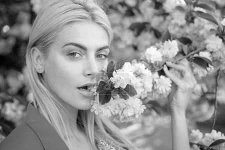 Téléchargez les photos : Gros plan visage de filles de printemps dans les fleurs - en image libre de droit