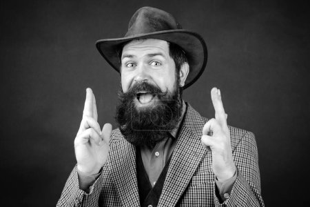 Photo for Hipster self confident man wearing retro style suit and hat. Cool bearded gesticulative man. Bearded macho man in suit and hat isolated at black background - Royalty Free Image