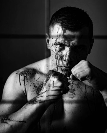 Photo for Psycho mad man. Psychic disease. Murderer brutal aggressive guy. Fight and attack. Aggressive person. Strong aggressive monster behind grid. Bodybuilder nude torso soiled blood. Prison for monster. - Royalty Free Image
