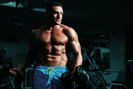 Photo for Sportman concept. Sport man in gym. Sporty male with naked torso. Workout guy. Exercises with dumbbells. Powerful athletic body. Sportsman - Royalty Free Image