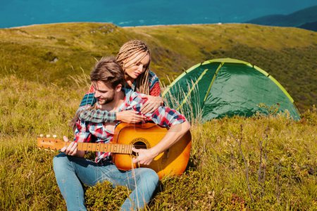 Photo for Couple camping. Weekend hike. People enjoying picnic on sunny day. Summer vacations. Love - Royalty Free Image