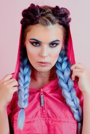 Photo for Pretty woman with colorful violet ombre hair and pro makeup isolated at pink background. Hairdresser salon concept. Beautiful stylish girl with colorful kanekalon braided in her hair - Royalty Free Image