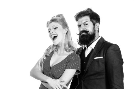 Photo for Funny retro couple. Crazy happy couple in love play tricks and have fun together. Cheerful smiling blonde woman and beard stylish man looking at camera. Woman wearing red dress and man in black suit - Royalty Free Image