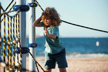 Photo for Boy playing in the playground. Kids play outdoor - Royalty Free Image
