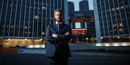 Photo for Executive businessman. Portrait of ceo near modern office in suit. Happy leader standing in front of company building - Royalty Free Image