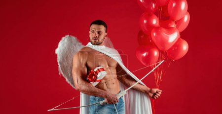 Photo for Valentines Day angel man. Sexy male with angels wings. Arrow of love, cupid, amour. February 14. Isolated on red - Royalty Free Image