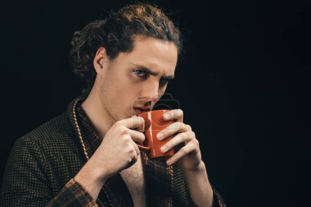 Photo for Handsome young man. Young man tense face on black background. Young handsome brunet. Drink tea or coffee. Stylish young man. Urban lifestyle concept - Royalty Free Image