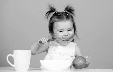 Photo for Baby food, babies eating. Little baby eating fruit puree - Royalty Free Image