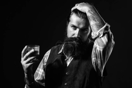 Photo for Bearded businessman in elegant suit with glass of whiskey. Sipping whiskey. Bearded handsome man holding glass of whiskey - Royalty Free Image