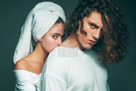 Photo for Beautiful young couple. Gorgeous woman with a towel on his head posing with handsome brunette man with sportive muscular body. Romantic and love. Young happy couple posing in studio. Sensuality - Royalty Free Image