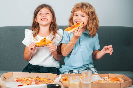 Photo for Hungry kids eating pizza. Little girl and boy eat pizza - Royalty Free Image