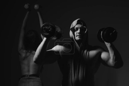 Photo for Sexy sport couple exercising with dumbbell. Slim and healthy sexy girl with strong muscular man workout - Royalty Free Image