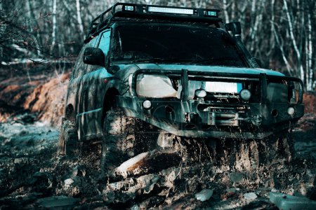 Photo for Off-road sport truck between mountains landscape. Track on mud. Off road car. Safari. Best off-road vehicles. Jeep crushed into a paddle and picked up a spray of dirt - Royalty Free Image