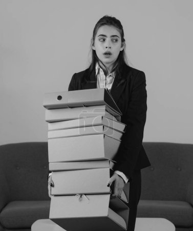 Photo for Portrait of young businesswoman accountant holding many folders with the documents in formal wear at office work place. Successful female manager, beautiful secretary girl - Royalty Free Image