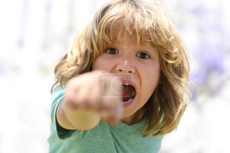 Photo for Enraged kid boy with angry expression. Angry hateful little rage boy, child furious. Angry rage kids face. Anger child with furious negative emotion portrait. Aggressive and mad kid angry behavior - Royalty Free Image
