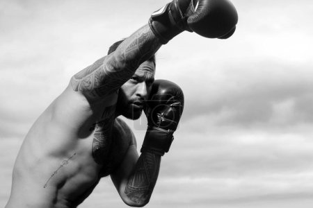 Photo for Portrait of tough male boxer posing in boxing gloves. Professional fighter ready for boxing match. Sportsman muay thai boxer fighting. Boxing punch - Royalty Free Image