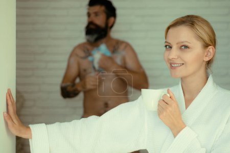 Photo for Romantic couple morning enjoying. Skincare in home bathroom. Happy young couple. Morning sexy couple. Handsome bearded man washing in bath. Everyday life. Morning - Royalty Free Image