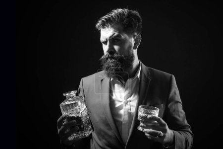 Photo for Man or businessman drinks whiskey on black background. Cheerful bearded man is drinking expensive whisky - Royalty Free Image
