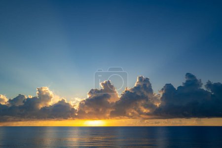 Photo for Sunset colors clouds. Sunset sea landscape. Colorful beach sunrise with calm waves. Nature sea sky. Caribbean sea. Sunrise with clouds of different colors against the blue sky and sea - Royalty Free Image