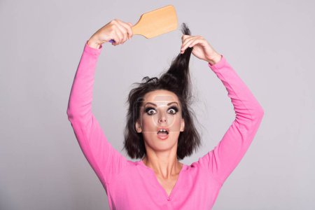 Photo for Sad girl with damaged hair. Haircare problem. Woman with hair loss problem. Portrait of young woman with a damaged bad hair. Girl with a hairbrush loosing hairs. Hair loss problem. Alopecia - Royalty Free Image