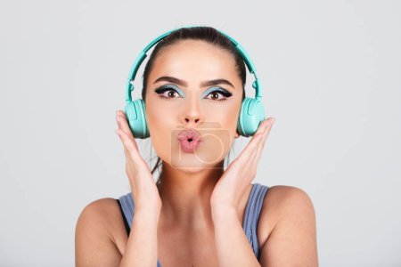 Photo for Close up portrait of of excited attractive girl in headphones listening music isolated on studio background. Podcast playlist audio track concept - Royalty Free Image