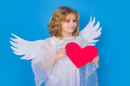 Photo for Angel kid with heart. Valentines day banner. Cute child with angel wings. Studio portrait of angel child on studio color isolated background with copy space - Royalty Free Image