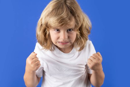 Photo for Child with angry expression. Angry hateful little boy, child furious. Angry rage kids face. Anger child with furious negative emotion portrait. Aggressive and mad kid bad behavior - Royalty Free Image
