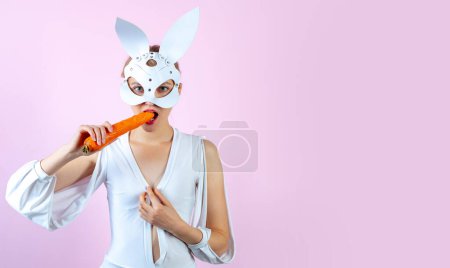 Photo for Cute bunny rabbit eat carrot. Easter carrot. Smile easter. Easter bunny dress. Easter banner, mockup copy space, poster flyer header for website template - Royalty Free Image