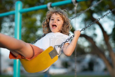 Photo for Little kid swinging portrait. Adorable child having fun on a swing on summer day - Royalty Free Image