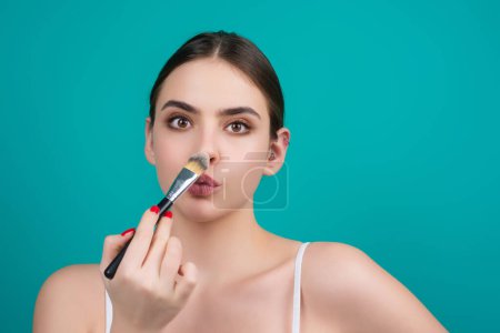 Photo for Woman apply powder on face. Beauty Makeup. Portrait of female model with cosmetic brush. Perfect soft skin and natural makeup. Applying powder blush highlighter, foundation tone - Royalty Free Image