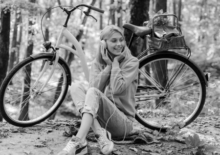 Photo for Musical pause. Enjoy relax forest. Girl ride bicycle for fun. Warm autumn. Girl with bicycle and headphones. Woman with bicycle autumn forest. Weekend activity. Active leisure and lifestyle. - Royalty Free Image