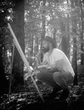 Photo for Capture moment. Bearded man painter looking for inspiration autumn nature. Drawing from life. Painter artist forest. Art concept. Painting in nature. Start new picture. Painter with easel and canvas. - Royalty Free Image