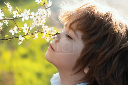 Photo for Happy childhood. Spring kid with blooming tree. Cute child in blossom garden - Royalty Free Image
