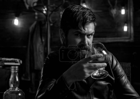 Photo for Man with beard holds glass brandy. Macho drinking. Degustation, tasting. Handsome stylish bearded man. Confident man - Royalty Free Image
