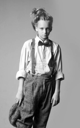Photo for Expressing myself with fashion. jazz step fashion. teen girl in retro male suit. vintage english style. suspender and bow tie. old fashioned child. retro fashion model. vintage charleston party. - Royalty Free Image
