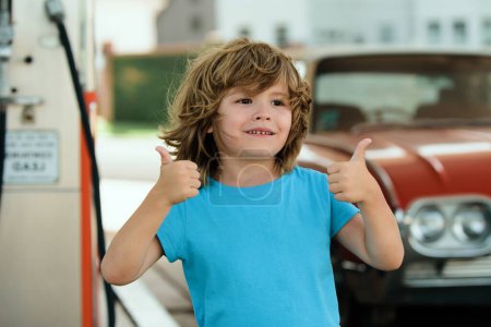 Photo for Kid refuel the car. Gas station. Red retro automobile - Royalty Free Image