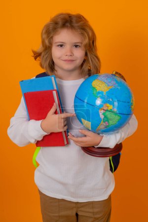 Photo for School children. School kid hold world globe and book. Back to school. Funny little student boy from elementary school with book. Pupil on studio isolated background - Royalty Free Image