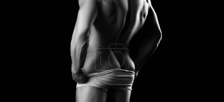 Photo for Muscular shirtless man showing ass in gray underwear against black studio background isolated. Im proud of you - Royalty Free Image