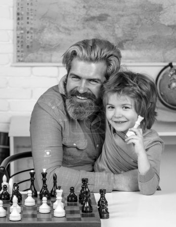 Photo for Cute little boy playing chess with Parents. Cute little boy playing chess with father. Father and son. Family relationship with son. Games and activities for children - Royalty Free Image